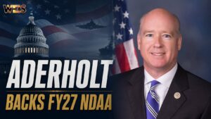 A WEIS Radio political news graphic featuring Congressman Robert Aderholt, the U.S. Capitol, an American flag, military aircraft, and a naval vessel following his vote for the FY27 National Defense Authorization Act.