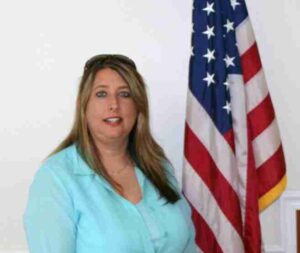 Former Cedar Bluff Mayor Tammy Grace Crane standing beside the American flag