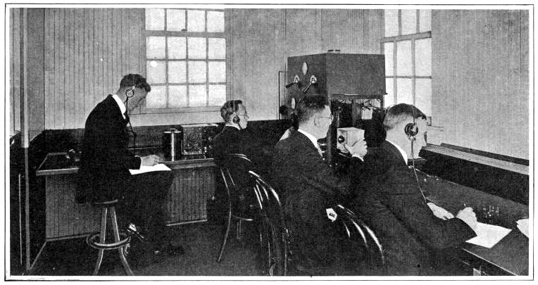 Announcer and radio operators inside an early KDKA transmission room.