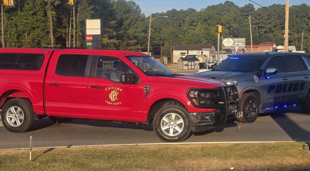 Centre Fire Department red Ford F-150 command vehicle parked outdoors, with its door emblem and a WEIS news headline.