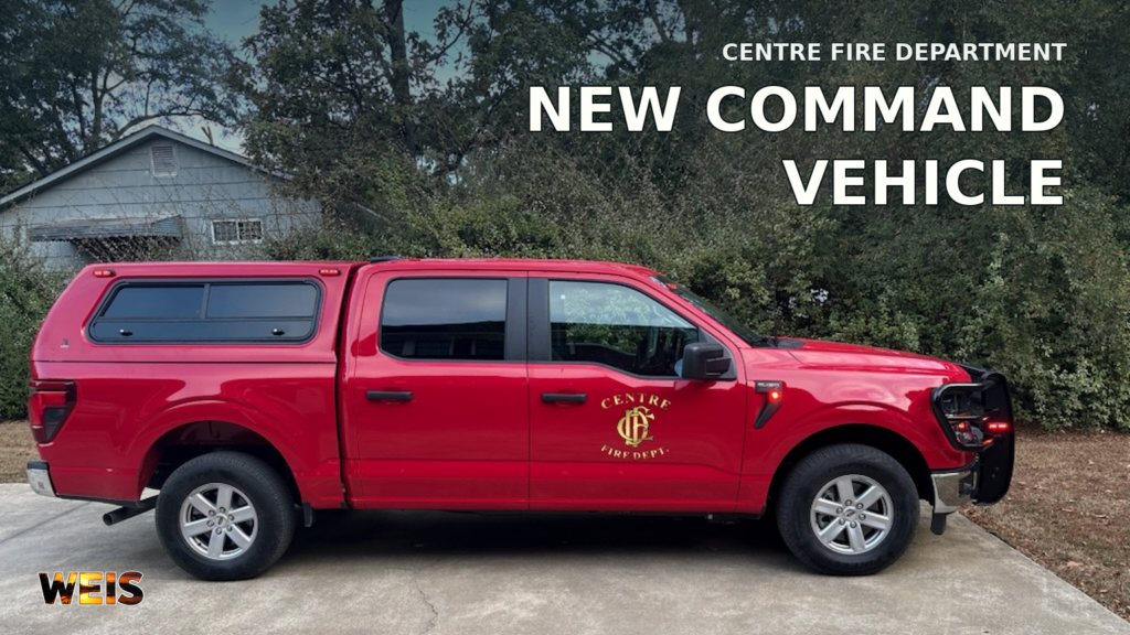 Centre Fire Department red Ford F-150 command vehicle parked outdoors, with its door emblem and a WEIS news headline.