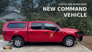 Centre Fire Department red Ford F-150 command vehicle parked outdoors, with its door emblem and a WEIS news headline.