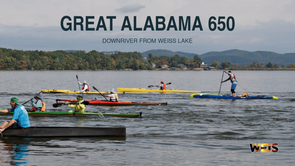 Great Alabama 650 paddlers in kayaks, a canoe, and a stand-up paddleboard on Weiss Lake, with WEIS branding.