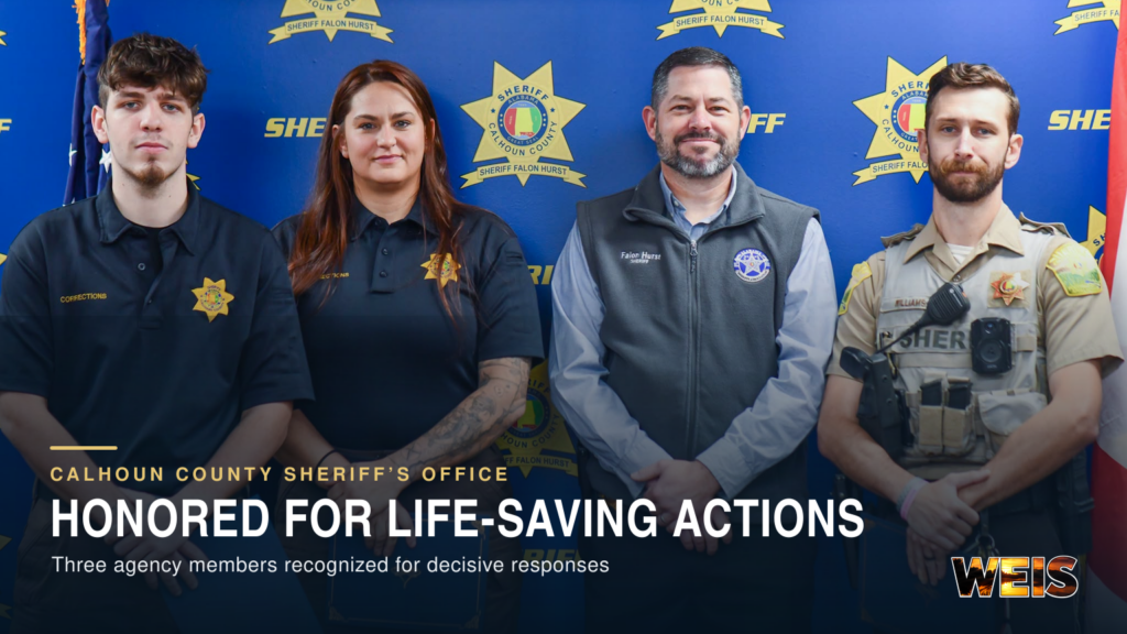 Three Calhoun County officers honored for lifesaving actions stand with Sheriff Falon Hurst during an award presentation