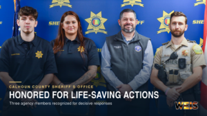 Three Calhoun County officers honored for lifesaving actions stand with Sheriff Falon Hurst during an award presentation
