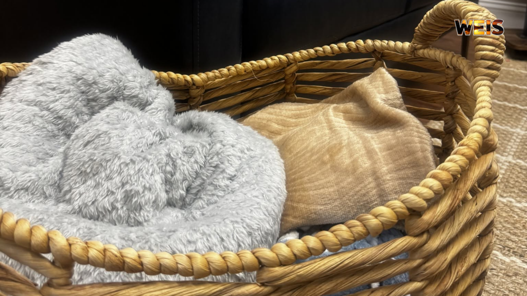 Gray and tan blankets in a woven basket illustrating the Cherokee County Children’s Advocacy Center’s blanket donations appeal.