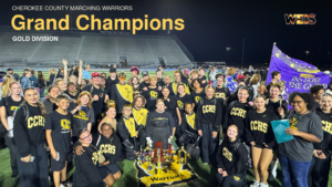 Cherokee County Marching Warriors celebrate with trophies after winning the Gold Division grand championship in Huntsville.