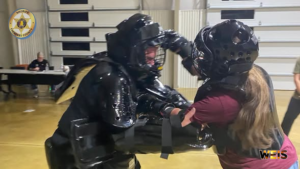 Participants in protective equipment practice during a Cherokee County Sheriff’s Office women’s self defense course.