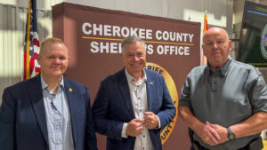 Three men at the Cherokee County Sheriff's Office Training Center for leadership training with Paul Butler in Leesburg.