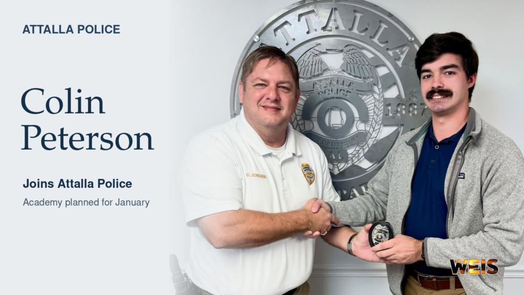 Attalla Police Chief Doug Jordan welcomes new officer Colin Peterson during a handshake and badge presentation.