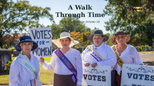 A Walk Through Time gallery photo showing women in period clothing holding Votes for Women signs at Forrest Cemetery.