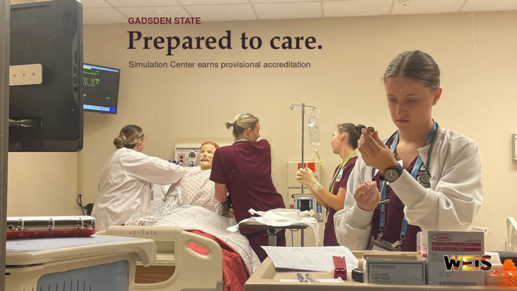 Gadsden State Simulation Center students practice patient care with a medical mannequin in a training room.