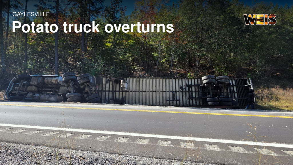 Gaylesville truck crash showing a potato-hauling tractor-trailer overturned beside Alabama Highway 35.